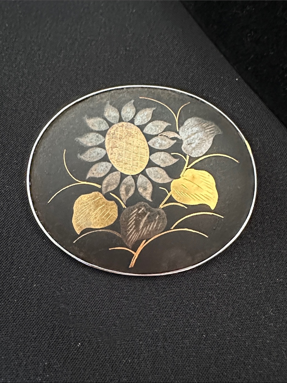 Vintage damascene GUC oval brooch. Sunflower theme in gold & silver on black